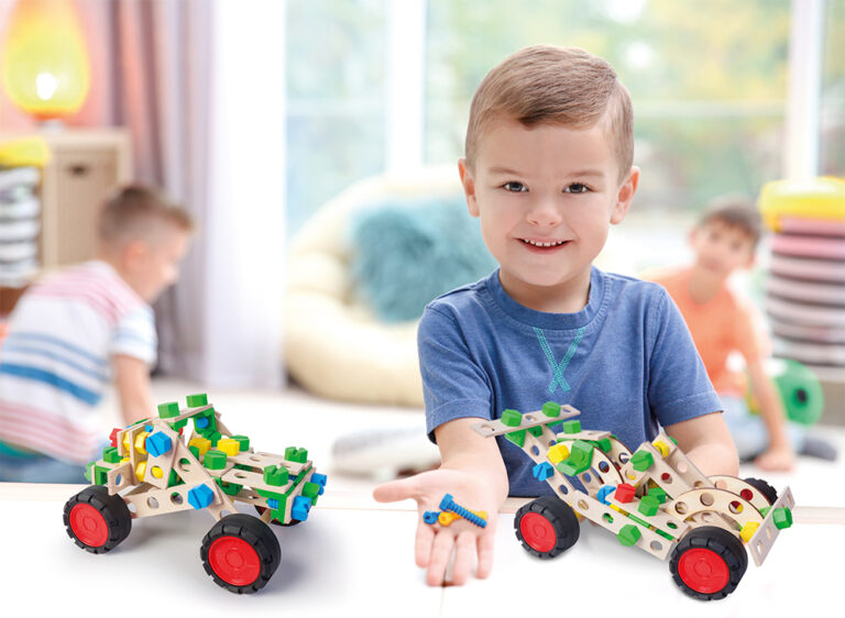 Little boy engaged in playdough modeling at daycare